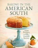 pound cake sitting on a blue pedestal cake stand with fruit underneath