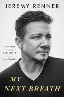 black and white photo of the author looking to the side wearing a black tee shirt