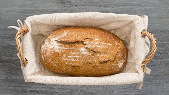 Loaf of homemade bread in a linen lined basket