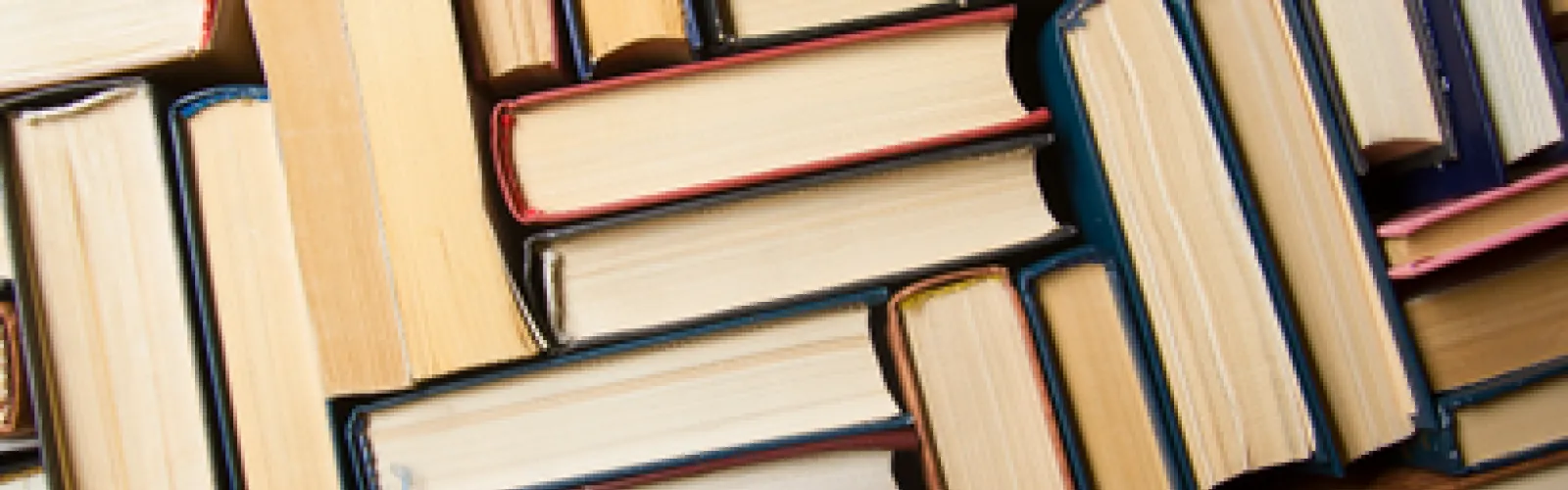 Books stacked on each other showing the ends of books.